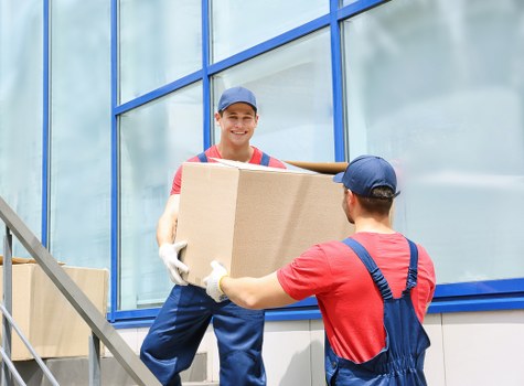 Professional office movers handling furniture